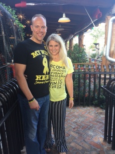 Wes and Nicole standing outside of Pappacitos Mexican Restaurant wearing their yellow shirts supporting sarcoma cancer awareness.